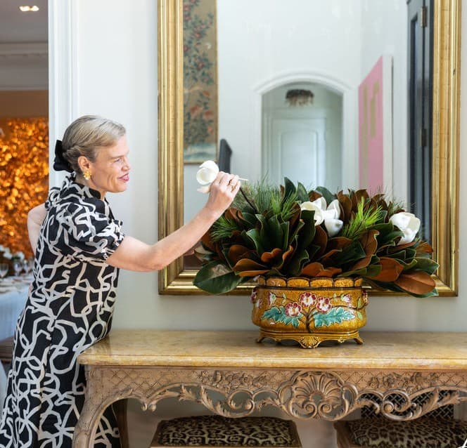 Erin Weston, founder of Weston Farms, holding magnolia foliage featured in The Dove Collection.
