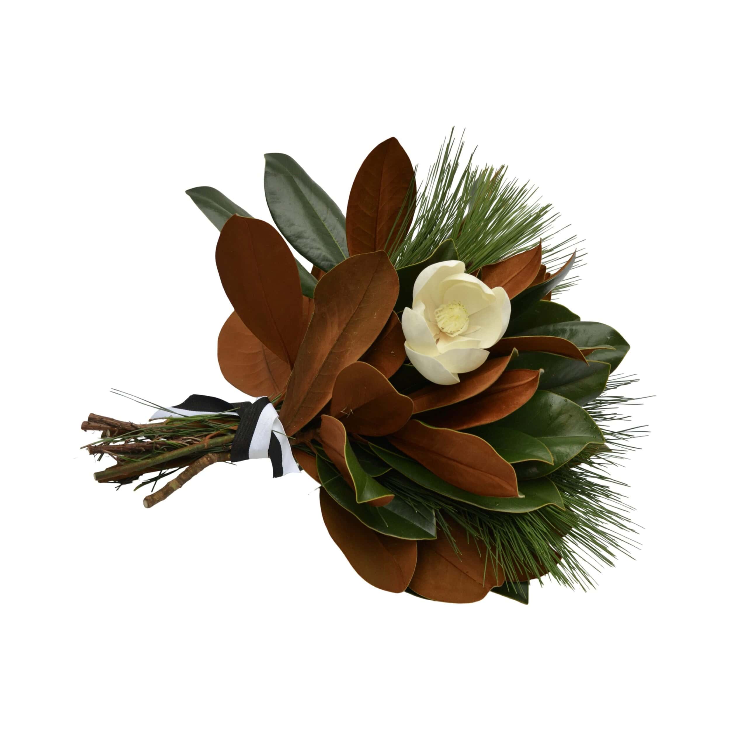 Close-up of fresh magnolia leaves with white flower and ribbon details from The Dove Collection by Weston Farms.