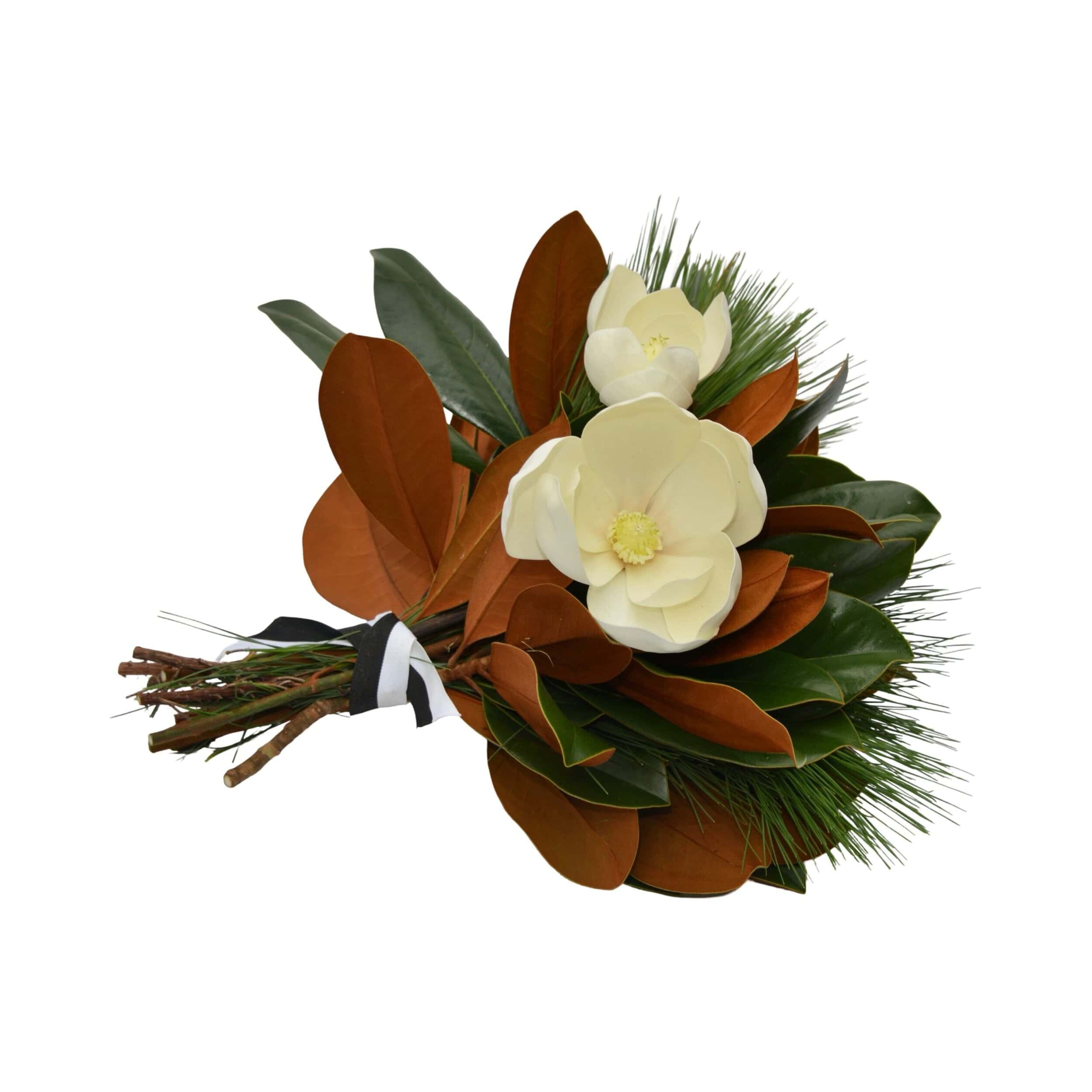 Close-up of fresh magnolia leaves with two white flowers and ribbon details from The Dove Collection by Weston Farms.