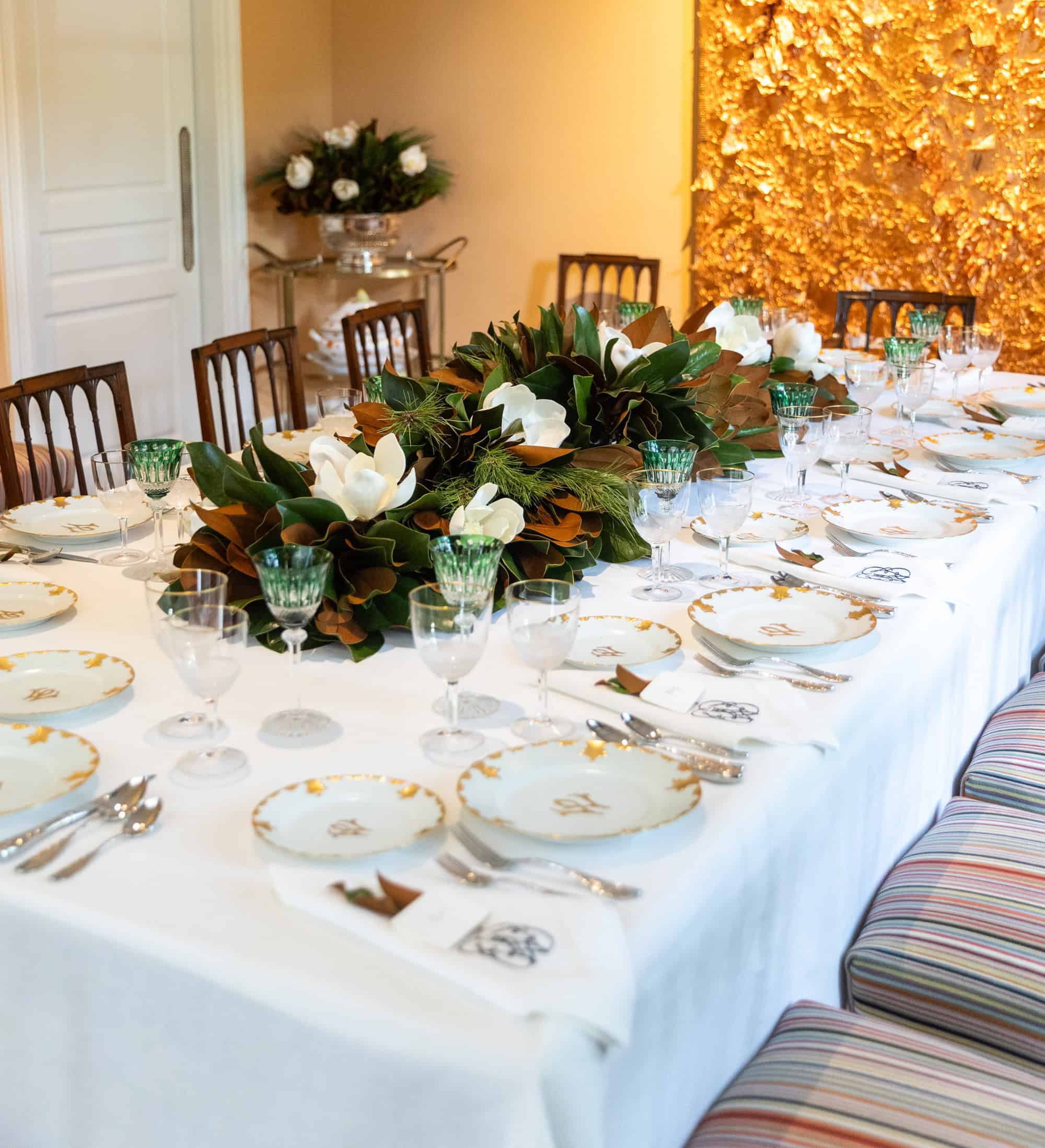 Elegant holiday table setting styled by Kimberly Whitman using magnolia greenery from The Dove Collection.