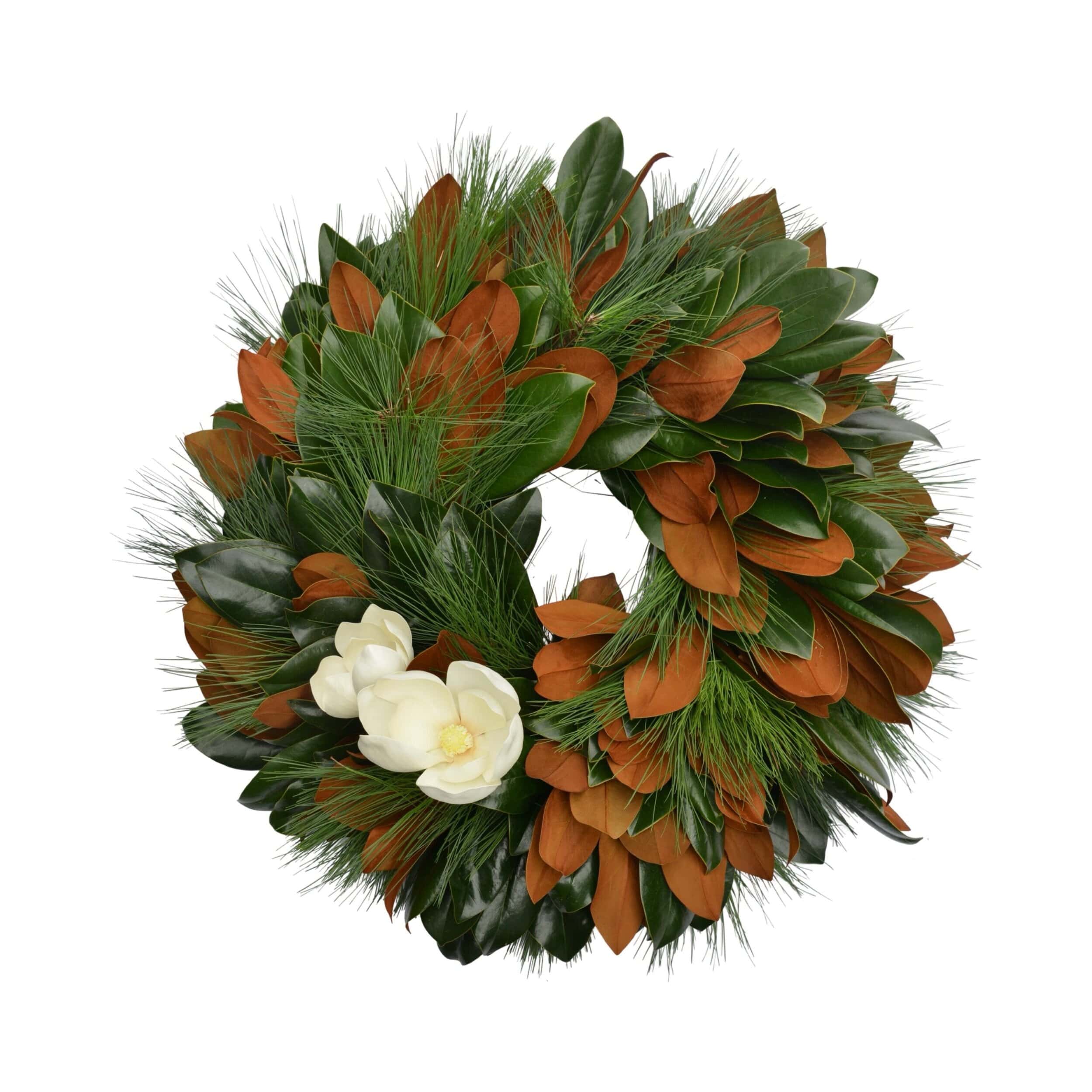 Close-up of fresh magnolia leaves wreath with white flowers from The Dove Collection by Weston Farms.