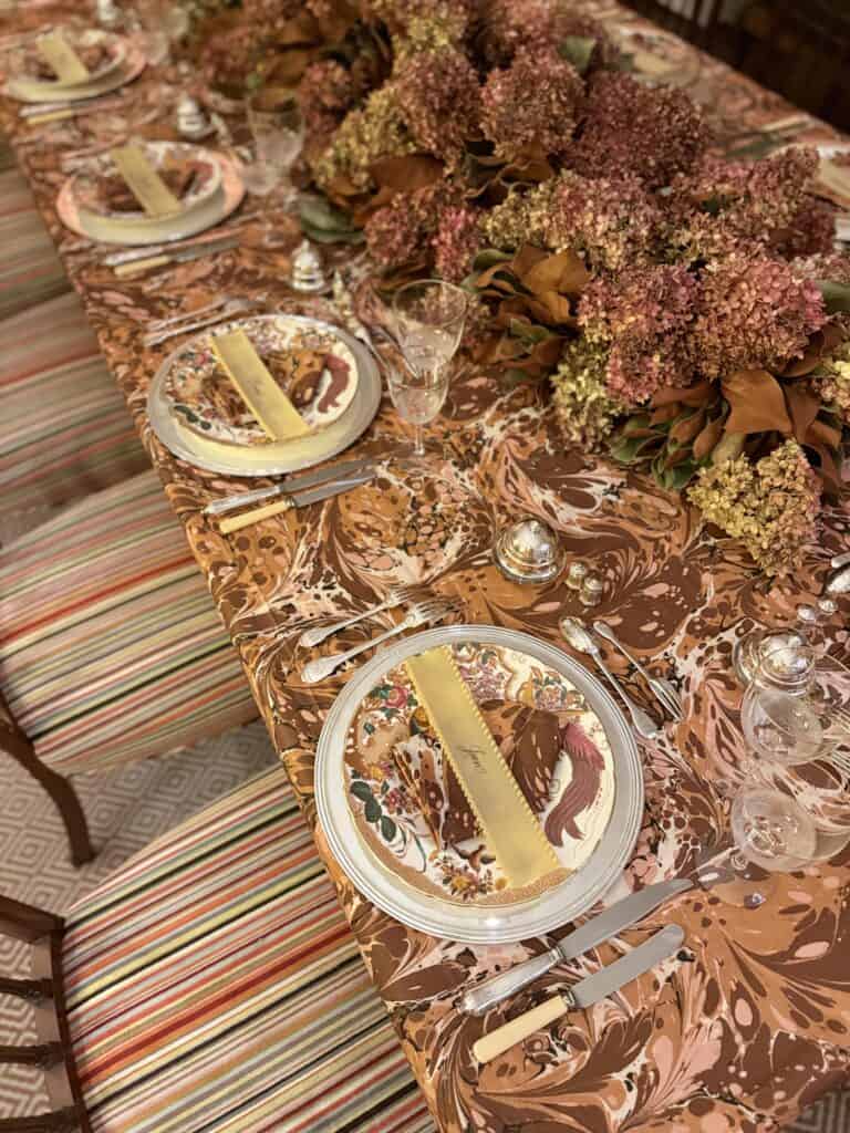 Fall Tablesetting with a patterned tablecloth and ravioli placecard.
